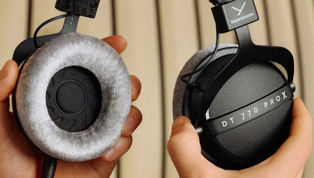 Flat lay of latest tech gadgets including laptops, headphones, camera, and audio gear.